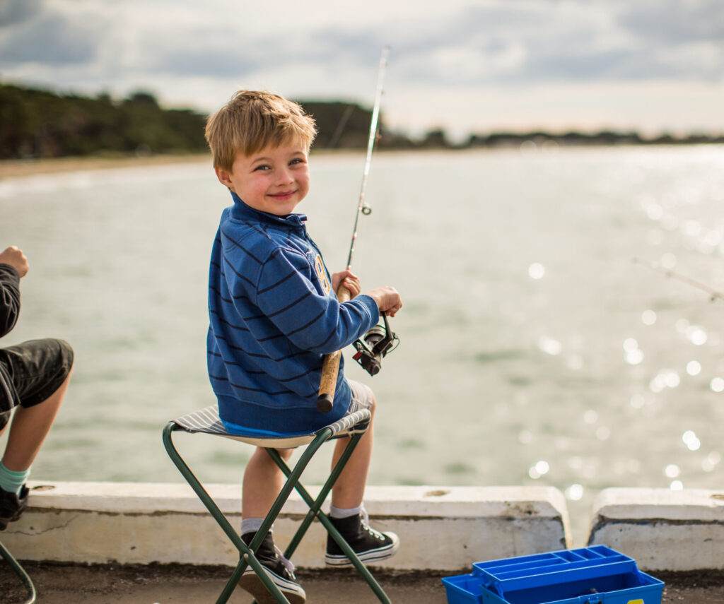 Young boy foshing at long Jetty Port welshpool