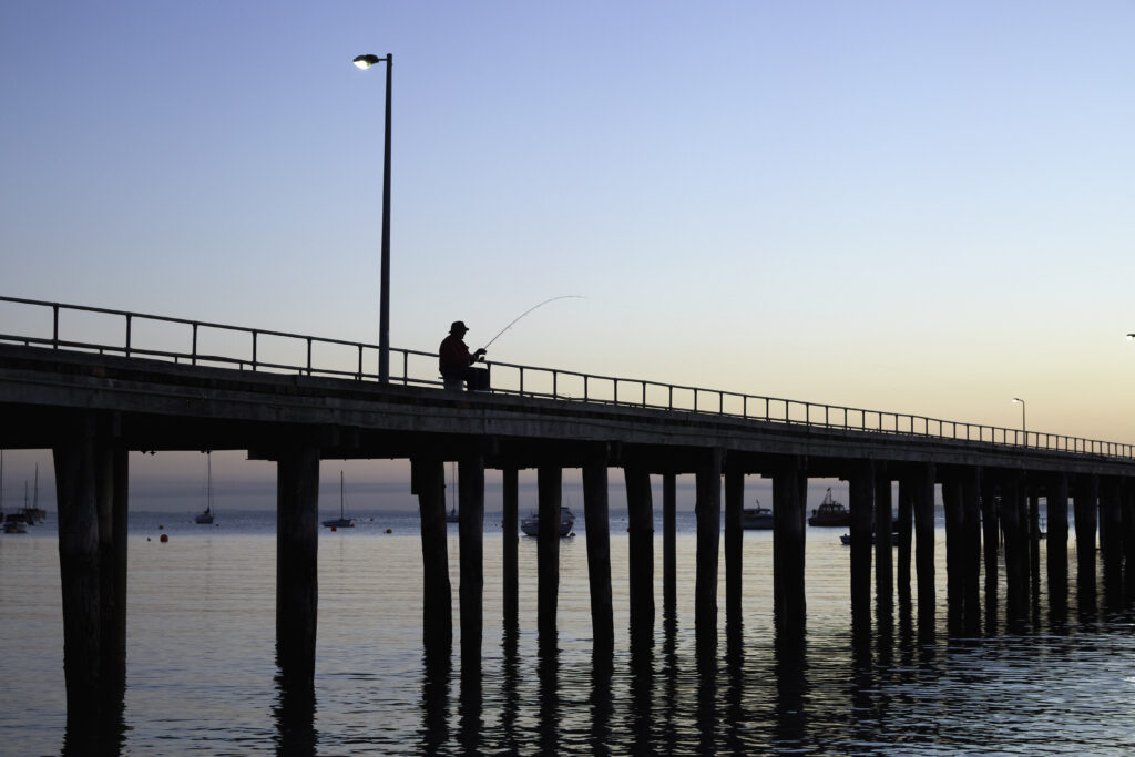 Fishing on the pier at sunset Fishing on the pier at sunset
