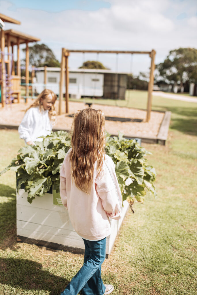 Kids usinging our communal Veggie Garden at BIG4 Long Jetty Caravan Park