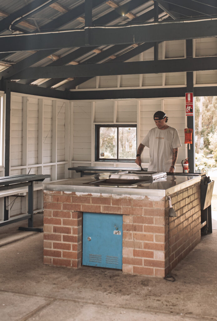 Man cooking in a outdoor camp kitchen