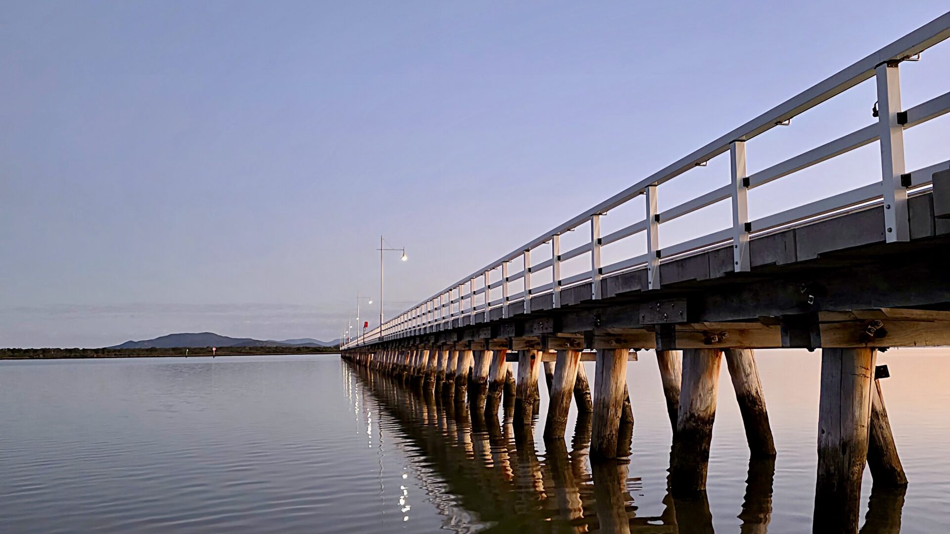 An image of the Long Jetty at sunset with glass like water