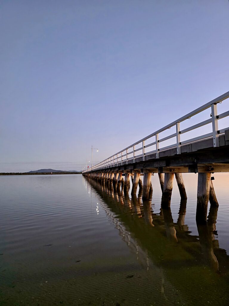 An image of the Long Jetty at sunset with glass like water